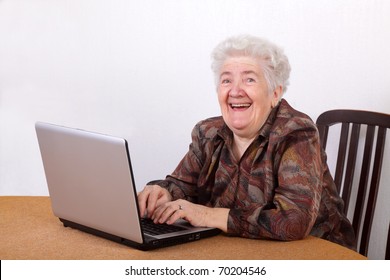 portrait-laughing-senior-woman-working-260nw-70204546.jpg
